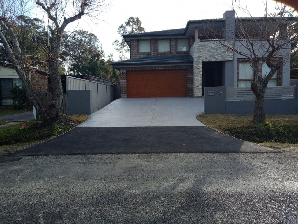 Asphalt driveway meeting a concrete apron on the Central Coast