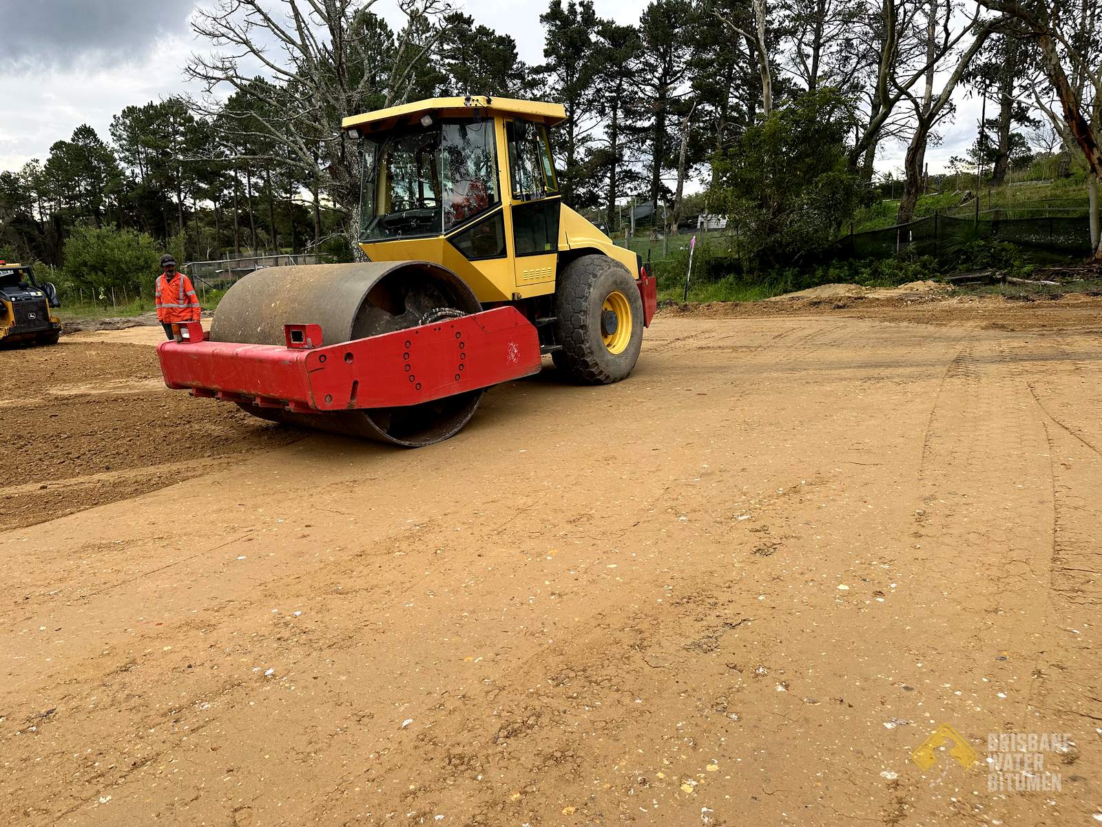 Road base being compacted before asphalt on a Central Coast site