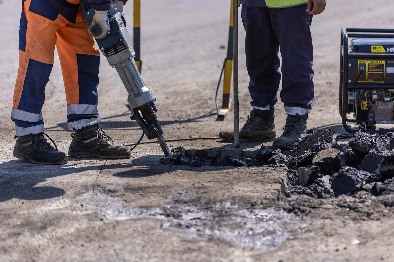 Jackhammer break-out of failed asphalt β saw-cut prep