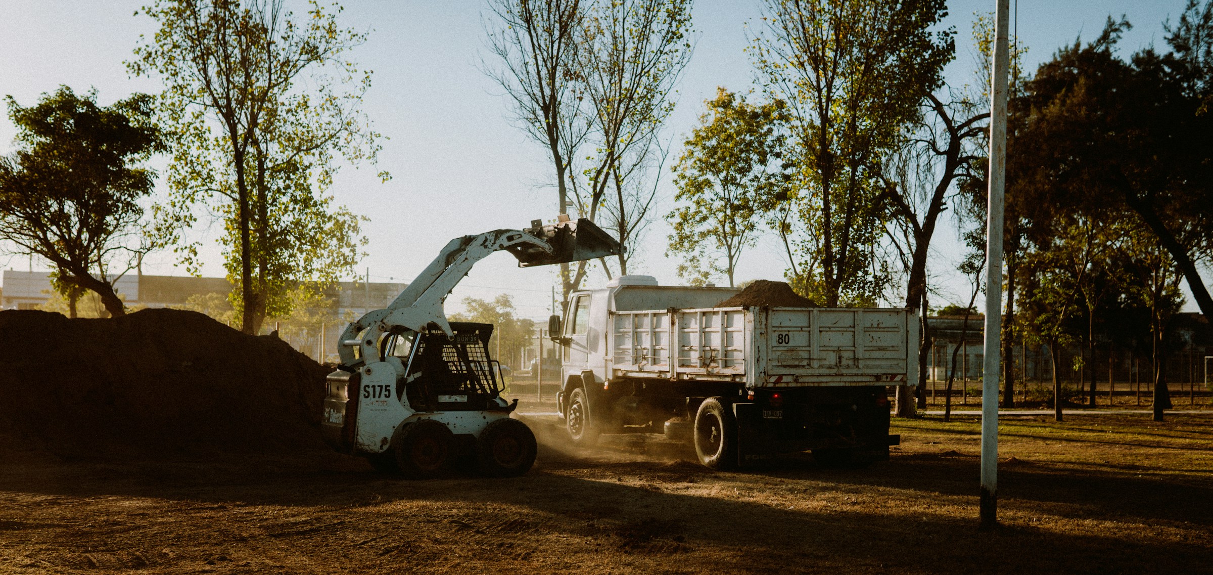 Bobcat and excavator on a Central Coast demolition and site preparation job