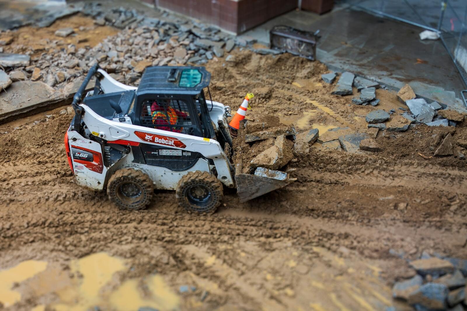 Bobcat S66 skid-steer breaking out concrete pavement