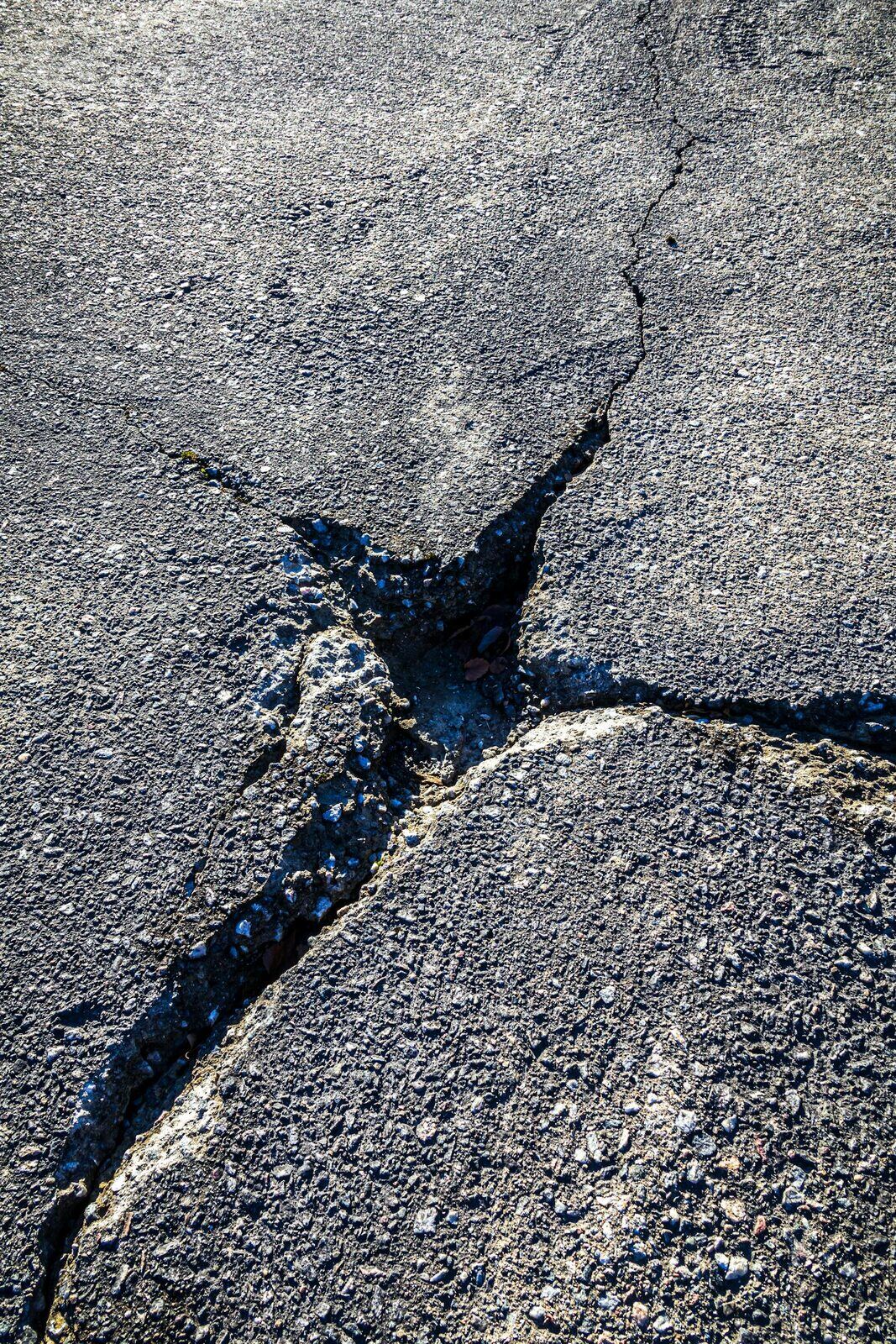 Cracked asphalt surface close-up