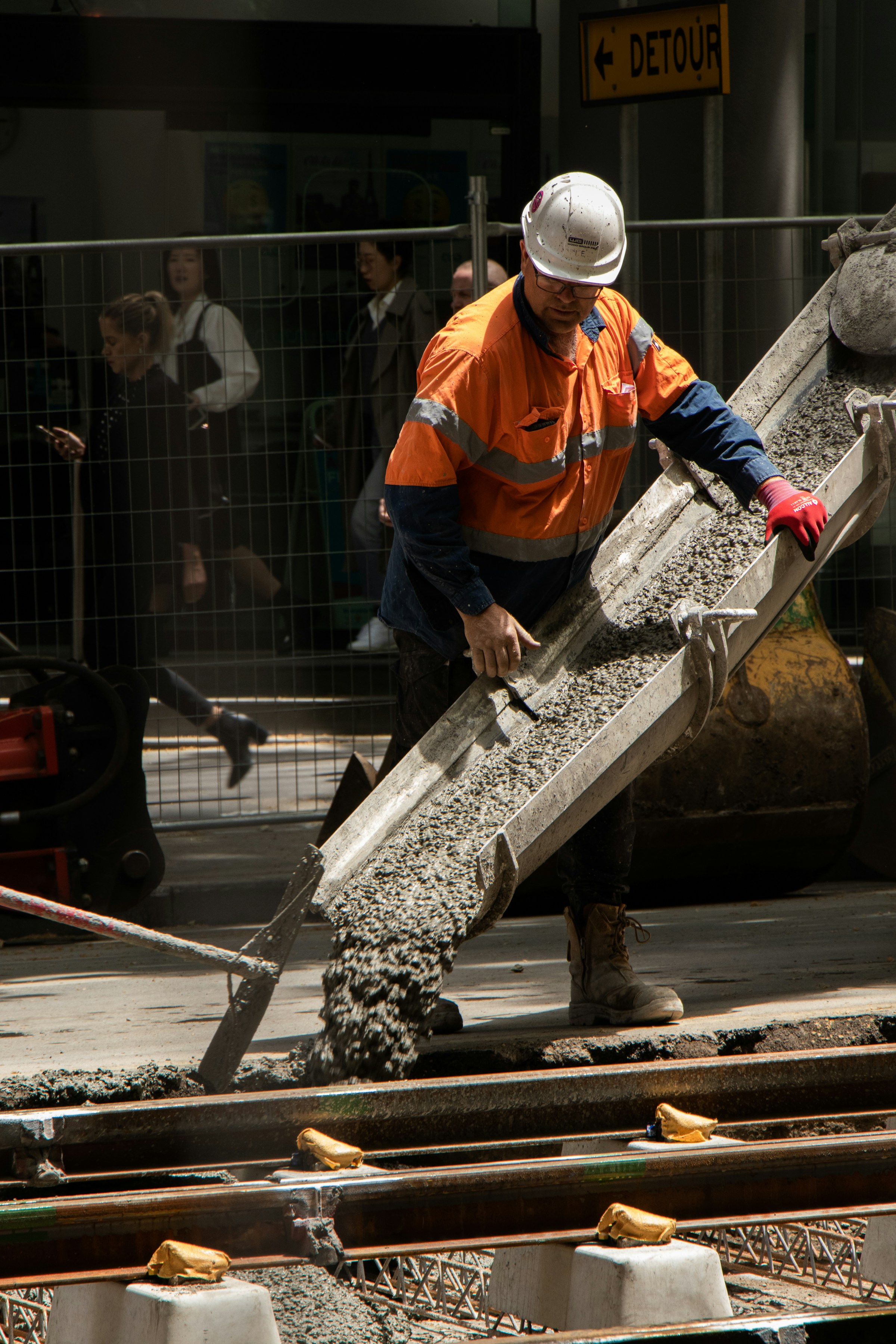 Concrete chute pour onto reinforced base — kerb installation