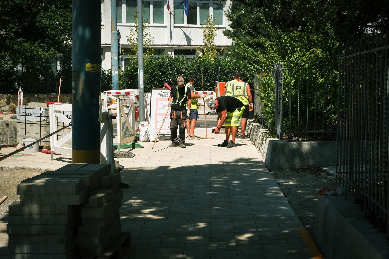 Footpath construction crew finishing a paver path