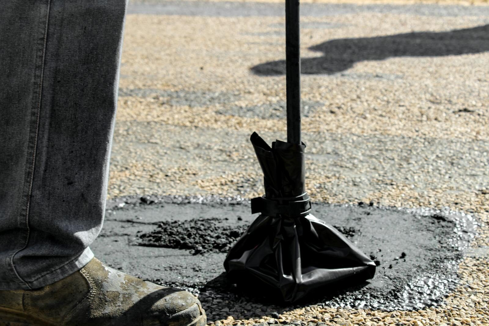 Crew compacting hot-mix patch with hand rammer