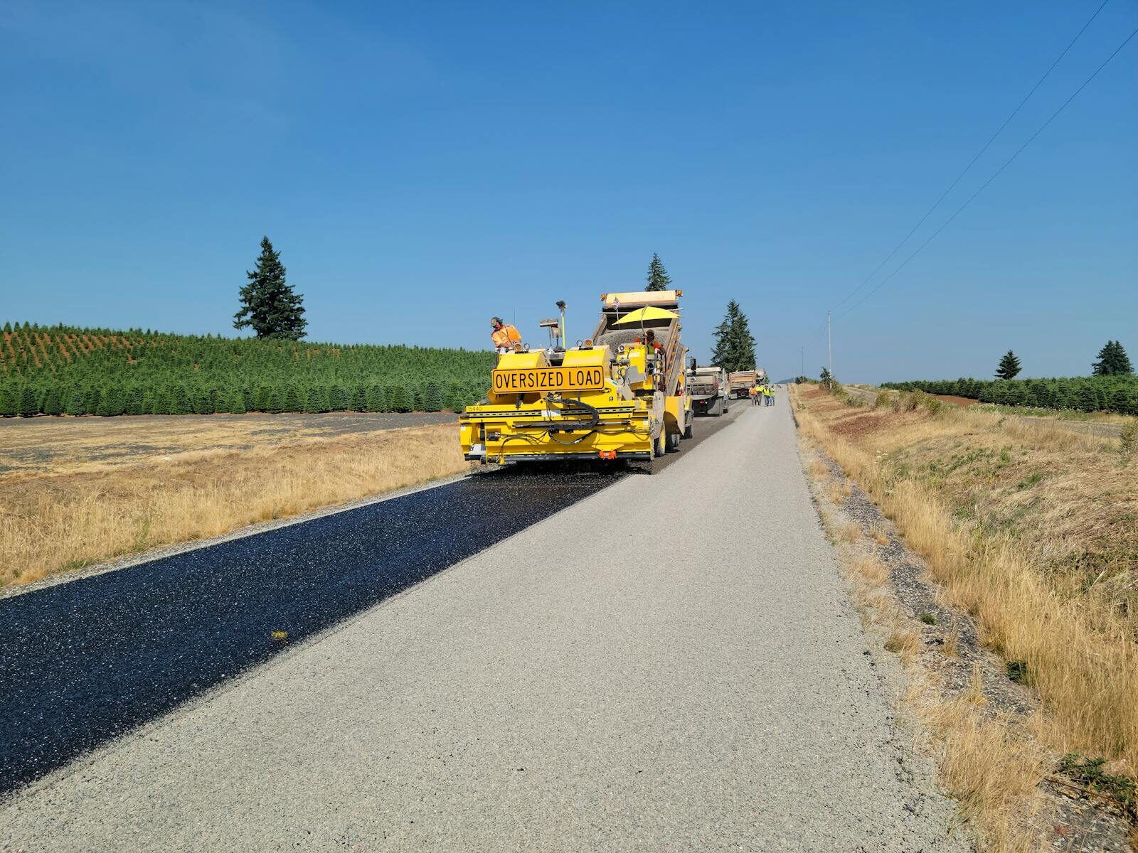 Rural road construction paving crew