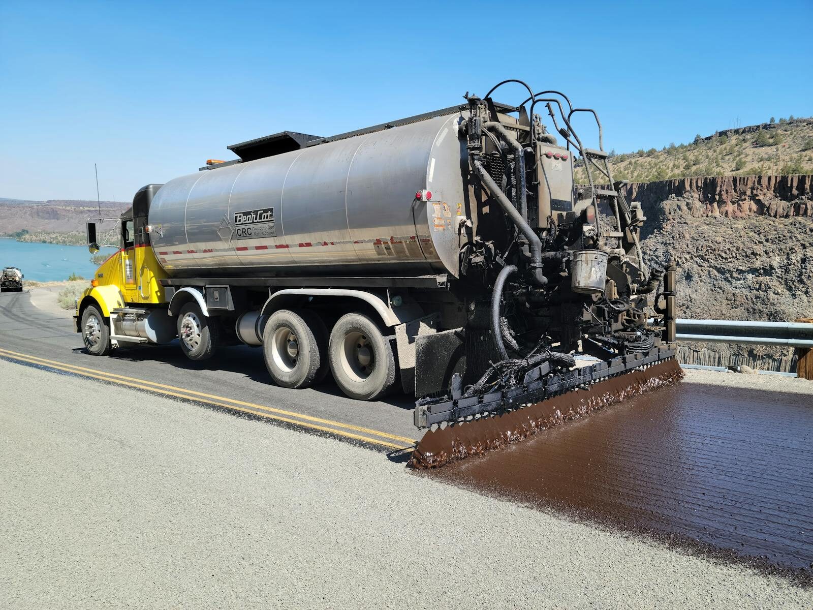 Bear Cat distributor truck applying fresh bitumen spray seal